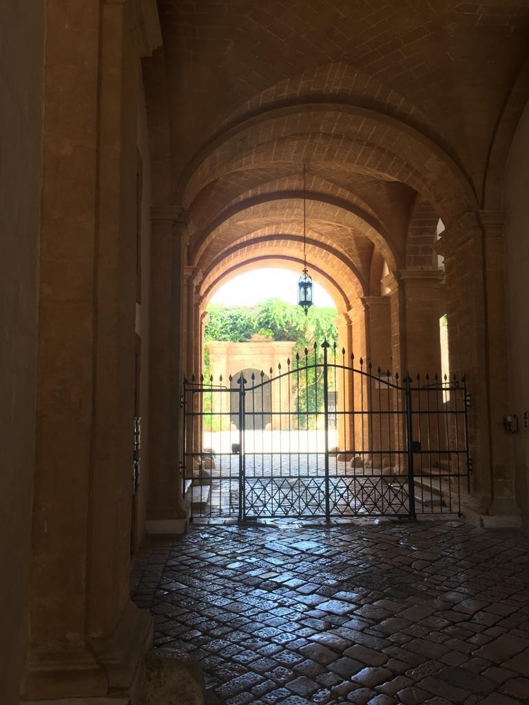 Vaulted entrance and wrought-iron gate of a courtyard in the old town of Manduria, Salento, Puglia